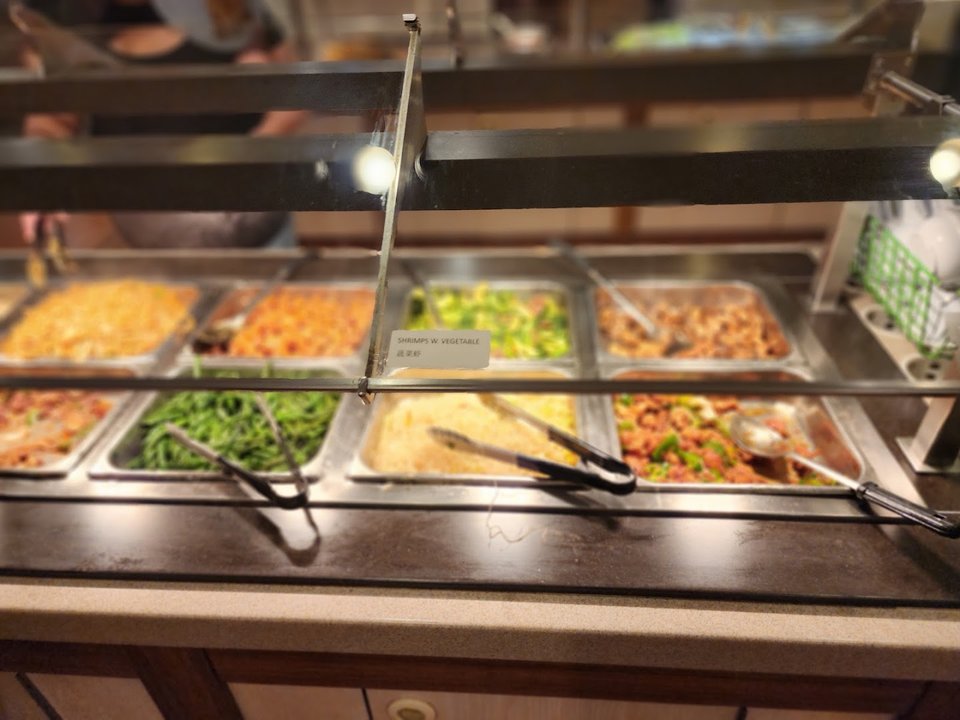 Buffet trays with sushi and seafood.
